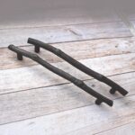 Rustic cast iron tree branch cabinet handle in antique black finish for drawers, cabinets, and furniture.