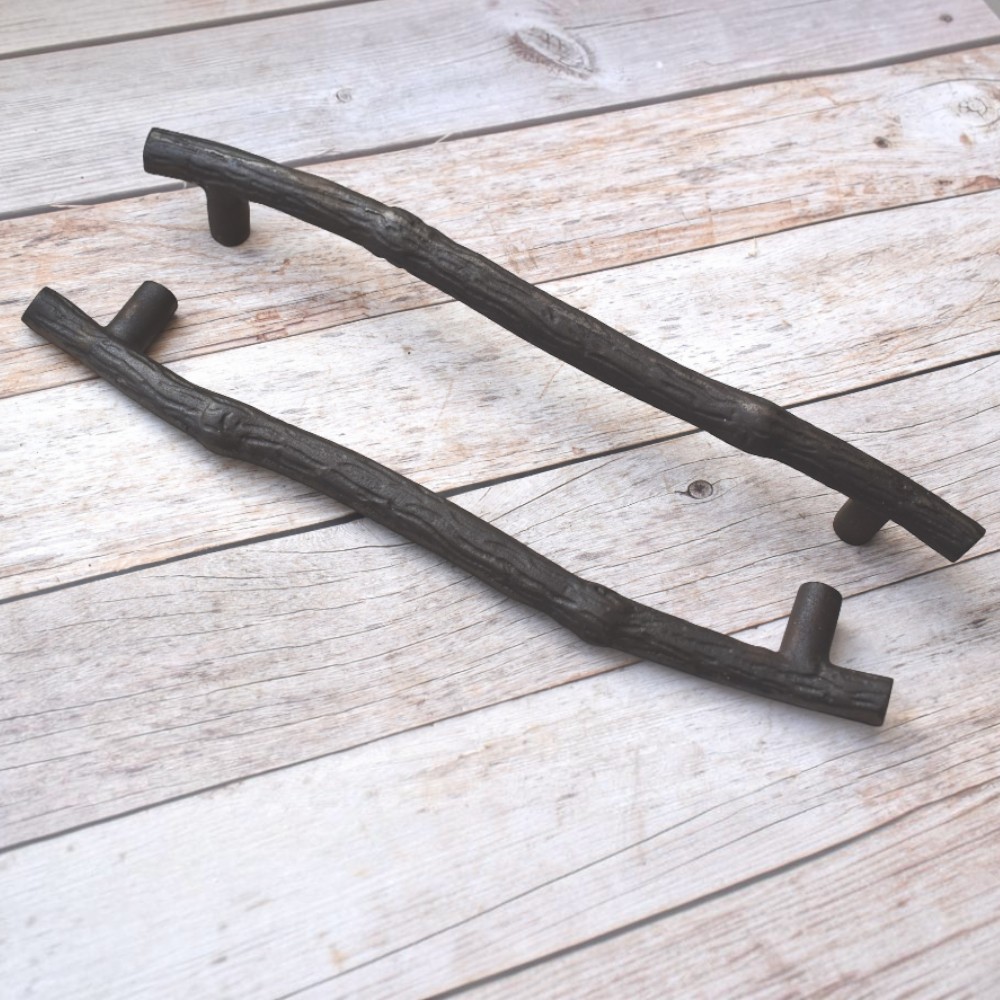 Rustic cast iron tree branch cabinet handle in antique black finish for drawers, cabinets, and furniture.