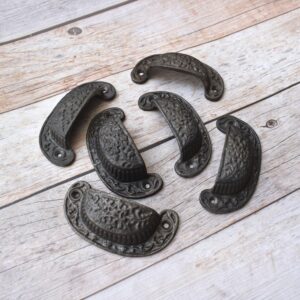 Vintage cast iron cup pull handle with antique rustic finish for cabinets, drawers, and furniture.