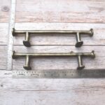 Premium antique brass iron cabinet pull handle for kitchen cabinets, drawers, wardrobes, dressers, and furniture with heavy-duty cylindrical design.
