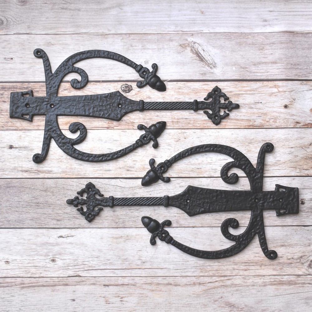 Decorative cast iron spear strap hinge pair with scroll design and antique black finish for barn doors, wooden gates, carriage doors, and farmhouse hardware.