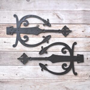 Decorative cast iron spear strap hinge pair with scroll design and antique black finish for barn doors, wooden gates, carriage doors, and farmhouse hardware.
