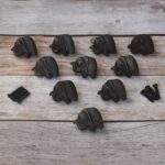Set of 10 cast iron elephant cabinet knobs with antique black finish and mounting screws for dresser drawers, kitchen cabinets, cupboards, wardrobe doors, and rustic furniture.