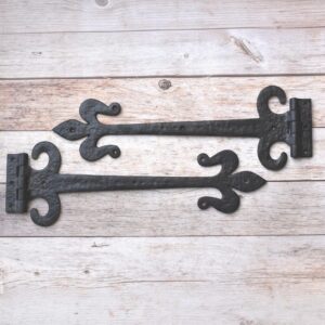 Pair of hand forged wrought iron Fleur de Lis strap hinges for barn doors, wooden gates, carriage doors, and rustic farmhouse décor.