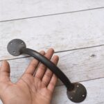 Enhance your doors with this handcrafted iron door pull handle pair. Featuring a rustic forged finish and heavy-duty construction, it's ideal for barn doors, wooden gates, entry doors, garages, and farmhouse décor.