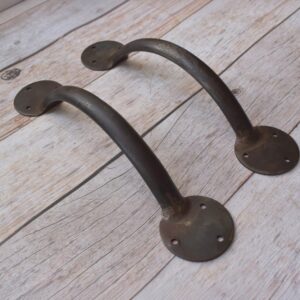 Enhance your doors with this handcrafted iron door pull handle pair. Featuring a rustic forged finish and heavy-duty construction, it's ideal for barn doors, wooden gates, entry doors, garages, and farmhouse décor.