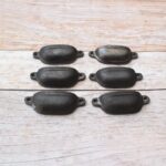 Plain cast iron cup pull handles with antique black finish for cabinets, drawers, and furniture.