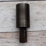 Steel round hardy tool stake holder for blacksmith anvil used in metal forging and fabrication.