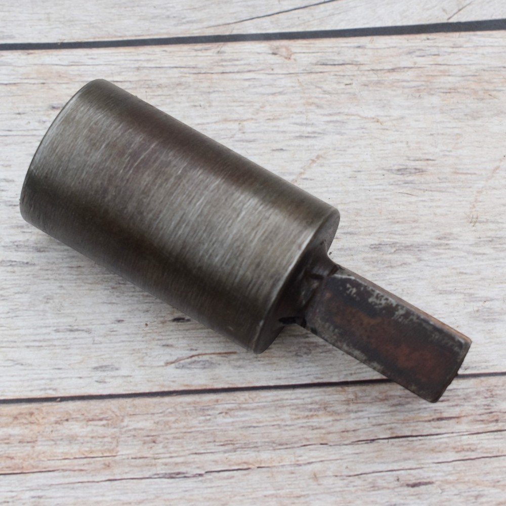 Steel round hardy tool stake holder for blacksmith anvil used in metal forging and fabrication.