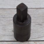 Steel round hardy tool stake holder for blacksmith anvil used in metal forging and fabrication.