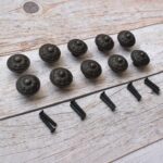 Set of 10 vintage cast iron floral cabinet knobs with mounting screws for drawers, cupboards, wardrobes, and furniture.