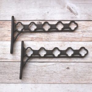 Heavy-duty cast iron hanging basket bracket with decorative quatrefoil design, antique black finish, ideal for hanging flower baskets, lanterns, bird feeders, and planters.