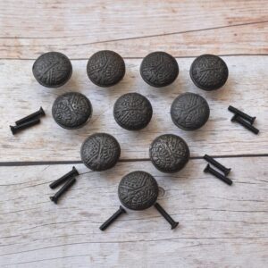 Set of vintage cast iron round cabinet knobs with embossed pattern and antique black finish for cabinets, drawers, cupboards, wardrobes, and furniture.