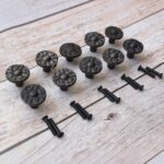 Set of 10 vintage cast iron round floral cabinet knobs with mounting screws for drawers, cabinets, wardrobes, cupboards, and furniture.