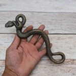 Vintage cast iron rattlesnake door pull handle with antique brass finish for barn doors, gates, cabinets, and rustic furniture.