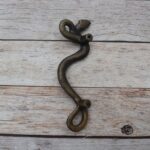 Vintage cast iron rattlesnake door pull handle with antique brass finish for barn doors, gates, cabinets, and rustic furniture.