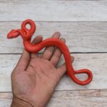 Red cast iron rattlesnake door pull handle for barn doors, gates, cabinets, wardrobes, and rustic furniture.