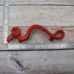 Red cast iron rattlesnake door pull handle for barn doors, gates, cabinets, wardrobes, and rustic furniture.
