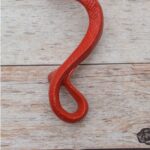 Red cast iron rattlesnake door pull handle for barn doors, gates, cabinets, wardrobes, and rustic furniture.