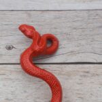 Red cast iron rattlesnake door pull handle for barn doors, gates, cabinets, wardrobes, and rustic furniture.