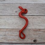 Red cast iron rattlesnake door pull handle for barn doors, gates, cabinets, wardrobes, and rustic furniture.