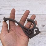 Set of 4 vintage cast iron double coat hooks with decorative detailing and dark rustic finish for coats, hats, bags, and home organization.