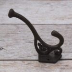 Set of 4 vintage cast iron double coat hooks with decorative detailing and dark rustic finish for coats, hats, bags, and home organization.