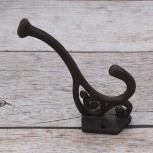 Set of 4 vintage cast iron double coat hooks with decorative detailing and dark rustic finish for coats, hats, bags, and home organization.