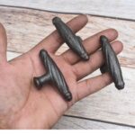 "Set of 10 vintage twisted rope iron T-handle cabinet knobs in rustic black finish with mounting screws, ideal for drawers, cupboards, dressers, wardrobes, and furniture restoration."