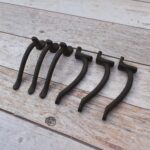 Set of 6 vintage hammered iron door pull handles with rustic dark finish for barn doors, cabinets, drawers, wardrobes, and furniture.