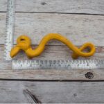 Yellow cast iron rattlesnake door pull handle for barn doors, gates, cabinets, wardrobes, and rustic furniture.