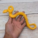 Yellow cast iron rattlesnake door pull handle for barn doors, gates, cabinets, wardrobes, and rustic furniture.