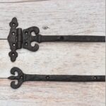 Pair of Ornate Fleur-de-Lis End Black Wrought Iron Strap Hinges