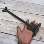 Pair of Ornate Fleur-de-Lis End Black Wrought Iron Strap Hinges